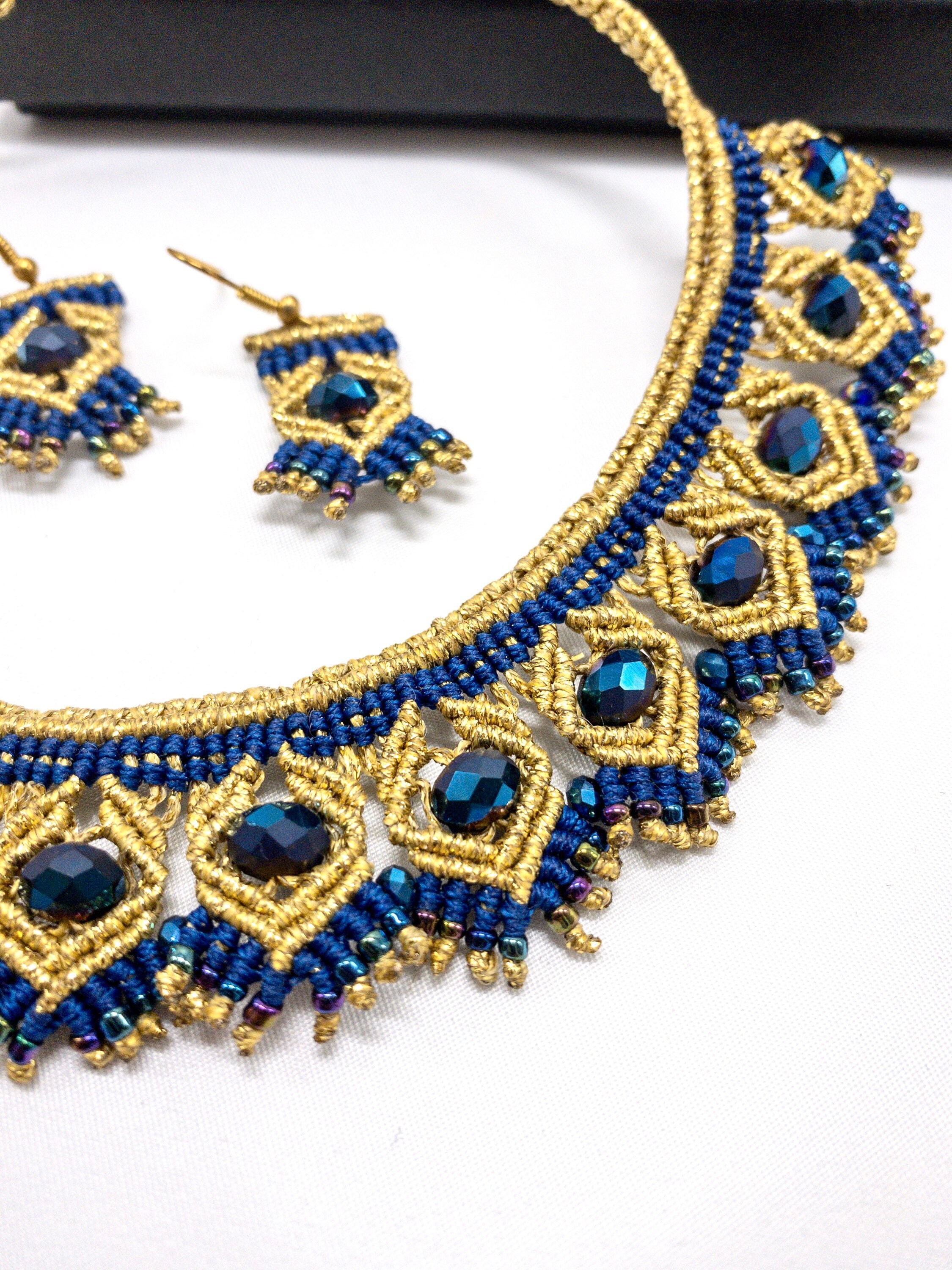 Close view of blue and gold macramé knotting and beadwork by Eve